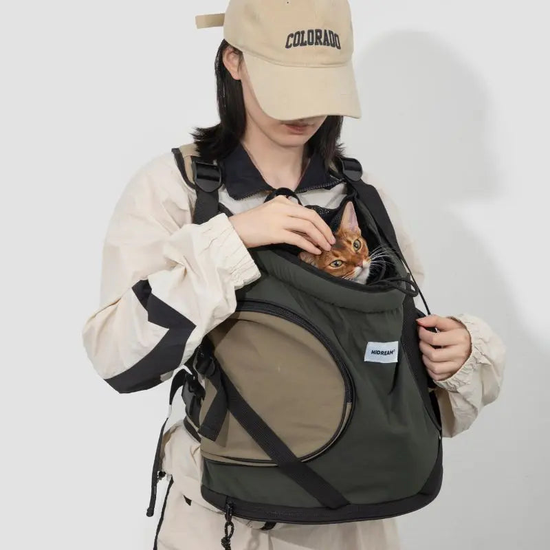 Person carrying Buckwheat Grey cat carrier backpack for small cats