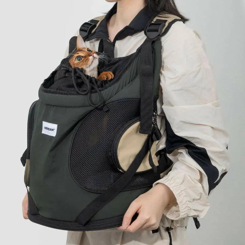 Person carrying army green cat carrier backpack for small cats