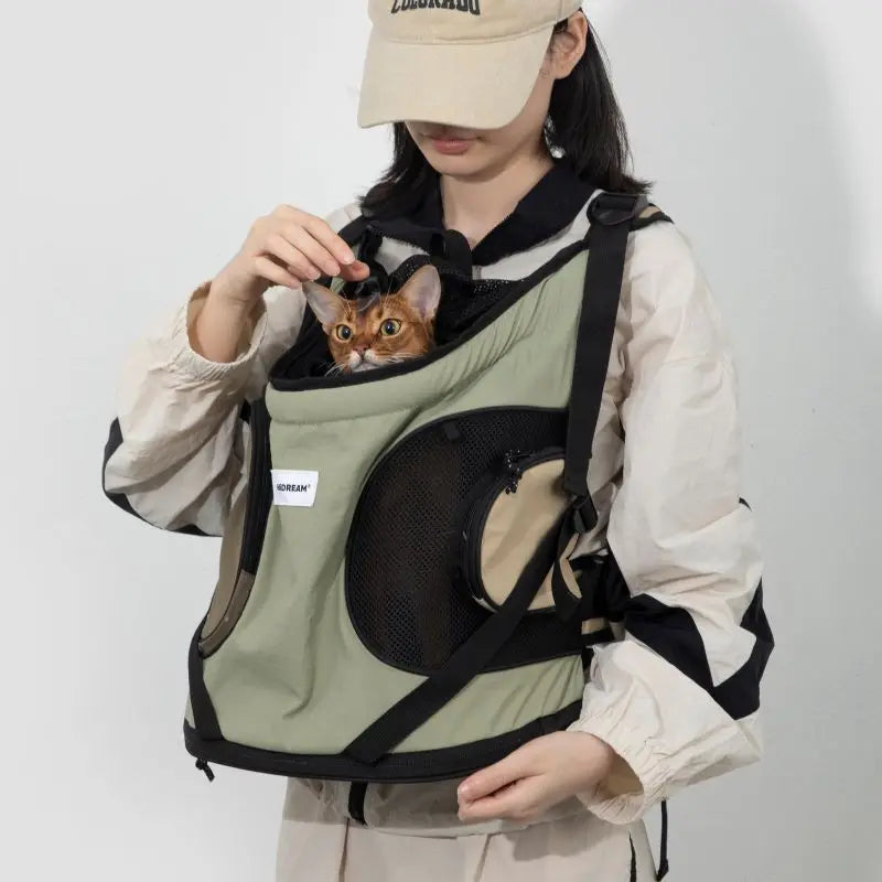 Person carrying green cat carrier backpack for small cats