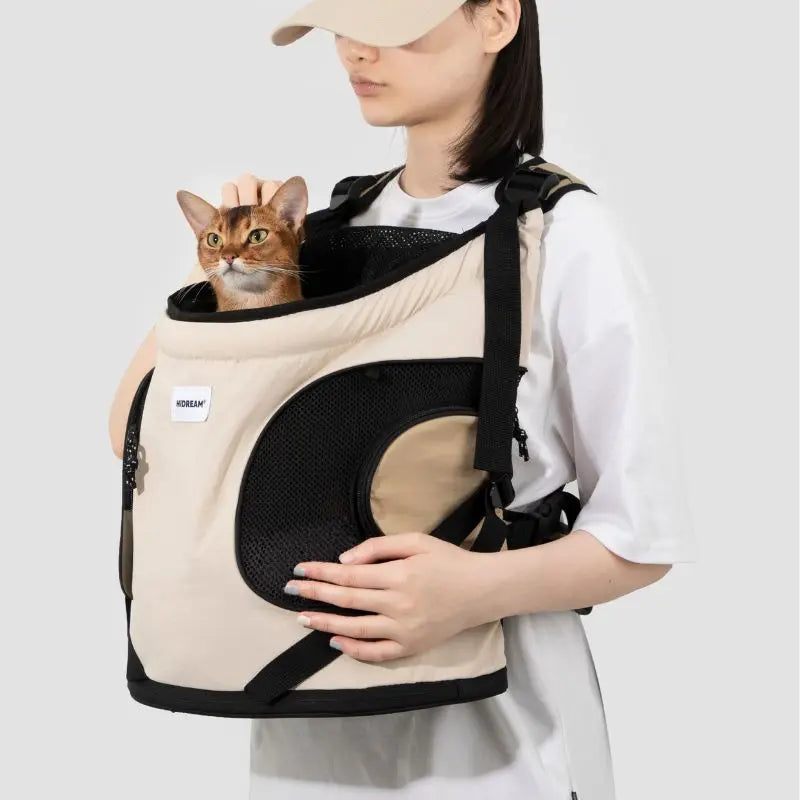 Person carrying khaki cat carrier backpack for small cats
