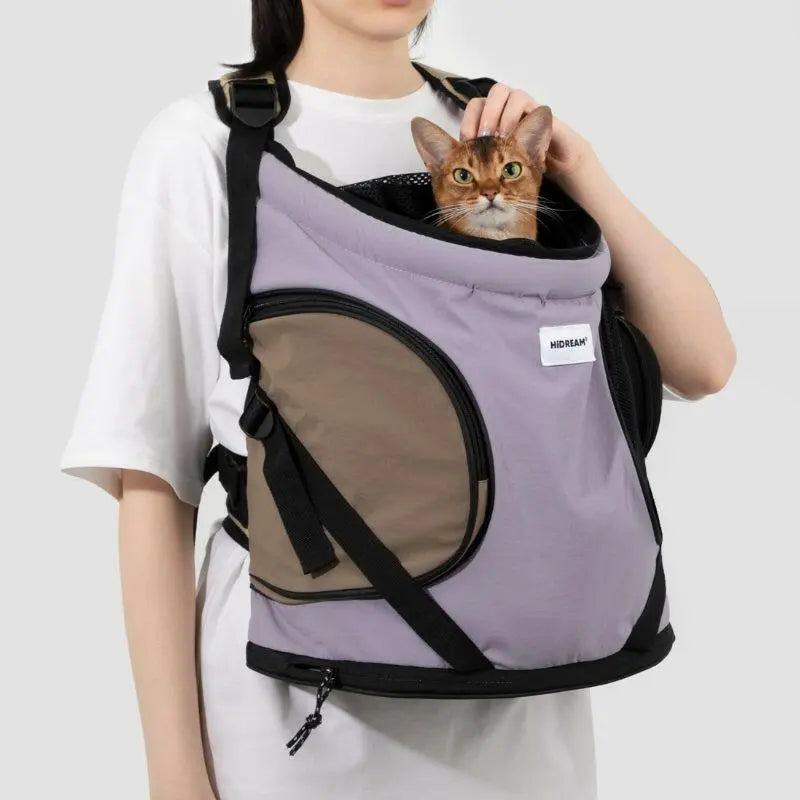 Person carrying purple cat carrier backpack for small cats